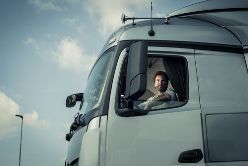 A Truck Driver Sitting in the Cab of a Truck